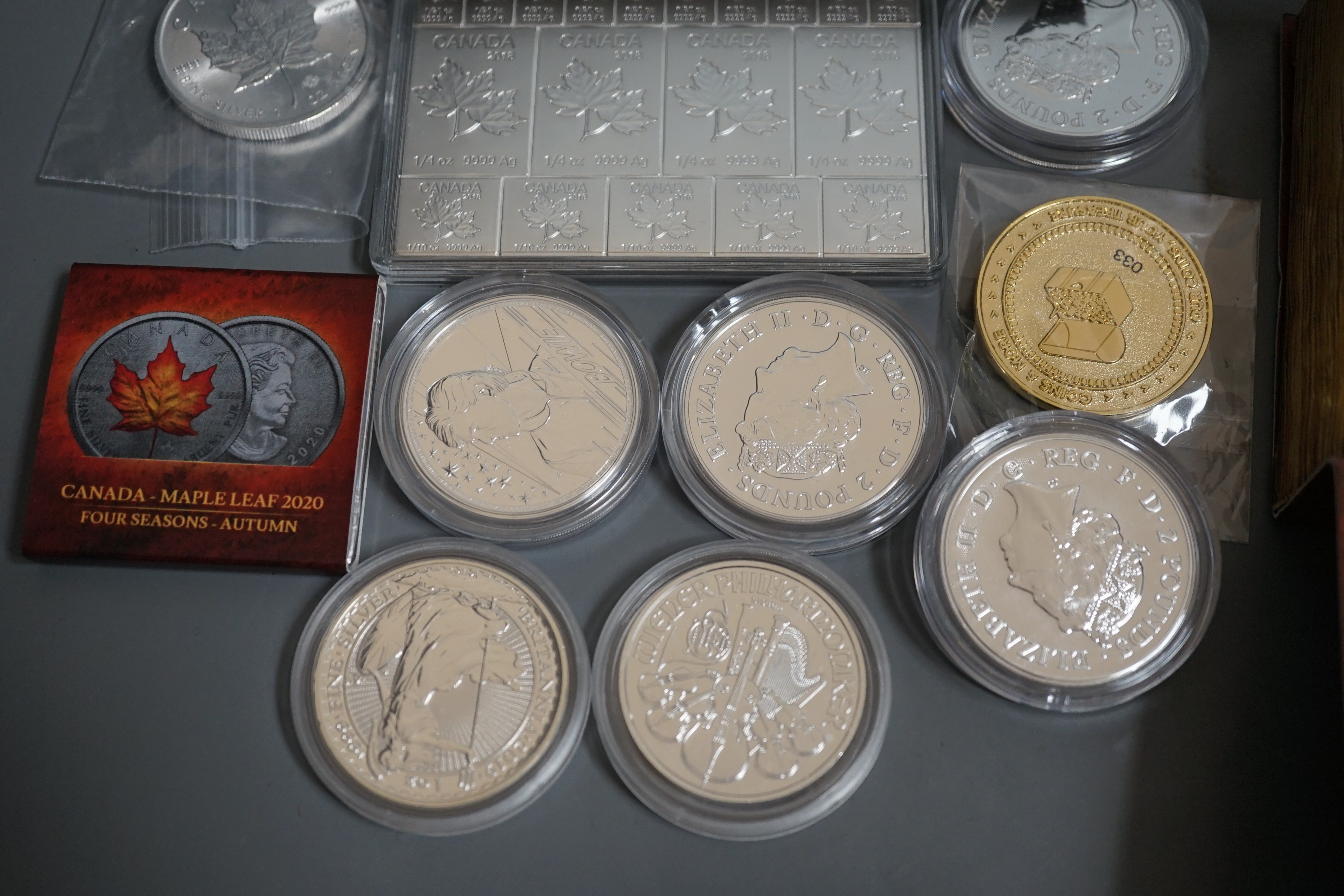 Ten bullion silver 1oz. commemorative coins, a bullion silver 2oz. coin and a Canada 2oz. silver ingot, BU
